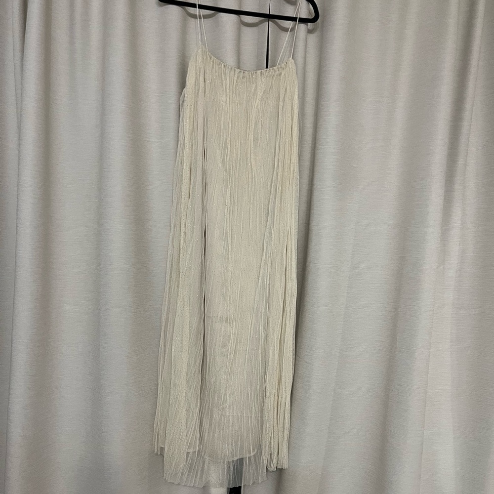 Spaghetti strap tulle dress with glittery gold dot details that catch the light